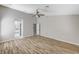 Large bedroom with light wood flooring, high ceilings, neutral walls, and open doorway to the en-suite bathroom at 1110 Azure Heights Pl, Las Vegas, NV 89110