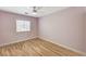 Bedroom featuring hardwood floors, white trim and a window bringing in natural light at 1110 Azure Heights Pl, Las Vegas, NV 89110