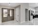 Inviting foyer showcasing stylish double doors and seamlessly connecting to the kitchen at 1110 Azure Heights Pl, Las Vegas, NV 89110