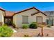 Charming single-story home with a red tile roof and manicured desert landscaping at 1110 Azure Heights Pl, Las Vegas, NV 89110