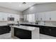 Well-lit kitchen with an island, stainless steel appliances, light countertops, and modern cabinets at 1110 Azure Heights Pl, Las Vegas, NV 89110