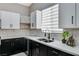Stylish kitchen featuring dark wood cabinetry, stainless steel sink, white countertops, and tiled backsplash at 1110 Azure Heights Pl, Las Vegas, NV 89110