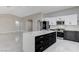 Spacious kitchen with black and white cabinets, granite countertops, stainless steel appliances, and a large island at 1110 Azure Heights Pl, Las Vegas, NV 89110