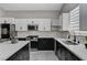 Modern kitchen with stainless steel appliances, an island, light countertops and a tiled backsplash at 1110 Azure Heights Pl, Las Vegas, NV 89110