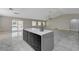 Open-concept living space featuring a large island, sleek floors, and an abundance of natural light at 1110 Azure Heights Pl, Las Vegas, NV 89110