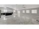 Bright, open-concept living space featuring a kitchen, sleek tile floors, and modern design at 1110 Azure Heights Pl, Las Vegas, NV 89110