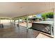 Covered patio has a hot tub and views of the backyard landscaping with pavers, and BBQ at 1110 Azure Heights Pl, Las Vegas, NV 89110
