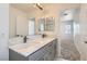 Bathroom features dual sinks, marble countertops, and modern fixtures with a large mirror at 1129 Paradise Vista Dr, Henderson, NV 89002