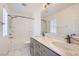 Bathroom with marble vanity, dual sinks, tub-shower combo and modern fixtures at 1129 Paradise Vista Dr, Henderson, NV 89002