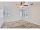 Bright bedroom with neutral carpet, ceiling fan, and multiple windows offering natural light at 1129 Paradise Vista Dr, Henderson, NV 89002