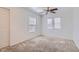 The bedroom features plush carpet, ceiling fan, and a window for natural light at 1129 Paradise Vista Dr, Henderson, NV 89002