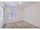 This bedroom features neutral carpet, a window, and closet at 1129 Paradise Vista Dr, Henderson, NV 89002