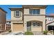 Charming two-story home with a tan stucco exterior, complemented by a one-car garage and well-maintained landscaping at 1129 Paradise Vista Dr, Henderson, NV 89002
