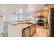 Bright kitchen boasts stainless appliances, tile floor, and eat-in counter, perfect for casual dining at 1129 Paradise Vista Dr, Henderson, NV 89002