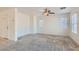 Bright living room with plush carpeting, fresh paint, and ample natural light from large windows creates a welcoming space at 1129 Paradise Vista Dr, Henderson, NV 89002