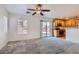 Bright living room features plush carpeting, large windows, and an open layout to the kitchen, perfect for Gathering gatherings at 1129 Paradise Vista Dr, Henderson, NV 89002