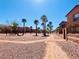 Picturesque walking path lined with mature trees and desert landscaping within the community at 1129 Paradise Vista Dr, Henderson, NV 89002