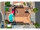 Aerial view of backyard featuring a kidney shaped pool, patio with pergola, and neatly maintained landscaping at 1142 Teal Point Dr, Henderson, NV 89074