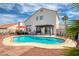 This backyard features a private pool, seating, and a covered patio perfect for relaxation and entertaining at 1142 Teal Point Dr, Henderson, NV 89074