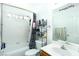 Cozy bathroom with a shower-tub combo, white tiled walls, a vanity with a sink, and an inspirational mirror at 1142 Teal Point Dr, Henderson, NV 89074