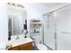Bright bathroom featuring shower, toilet, vanity, mirror, and shelving unit at 1142 Teal Point Dr, Henderson, NV 89074