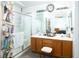 This bathroom features a double vanity with a framed mirror and a glass-enclosed shower for convenience at 1142 Teal Point Dr, Henderson, NV 89074