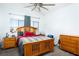 This bedroom offers natural light with wooden furniture including a dresser and bedside table for storage at 1142 Teal Point Dr, Henderson, NV 89074