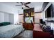Cozy bedroom with natural light, ceiling fan, guitars, and home office area at 1142 Teal Point Dr, Henderson, NV 89074