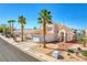 Beautiful two-story home with terra cotta roof, desert landscaping, and a two-car garage on a sunny day at 1142 Teal Point Dr, Henderson, NV 89074
