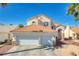Inviting two-story home boasts a terra cotta roof, stone accents, and a well-manicured front yard with a two-car garage at 1142 Teal Point Dr, Henderson, NV 89074
