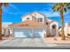 Inviting two-story home featuring a terracotta roof, a two car garage and desert landscaping at 1142 Teal Point Dr, Henderson, NV 89074