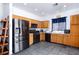 Functional kitchen with black appliances, wooden cabinets, and tiled flooring at 1142 Teal Point Dr, Henderson, NV 89074