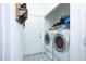 This laundry room offers a washer and dryer with storage shelves for laundry supplies at 1142 Teal Point Dr, Henderson, NV 89074
