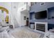 Inviting living room with tall ceilings, fireplace, stairway, and light grey flooring at 1142 Teal Point Dr, Henderson, NV 89074