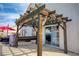 Backyard patio featuring a rustic pergola with string lights and a built-in grill at 1142 Teal Point Dr, Henderson, NV 89074