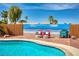 Backyard features a refreshing pool with red lounge chairs, enhancing the outdoor living space at 1142 Teal Point Dr, Henderson, NV 89074