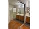 Bright bathroom featuring double sinks, shower stall, tile floors, mirrors, and ample storage space at 1286 N Sloan Ln, Las Vegas, NV 89110