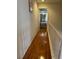 Hallway with wood floors leading to bedroom, enhanced by natural light and railing at 1286 N Sloan Ln, Las Vegas, NV 89110