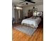 Large main bedroom with wood floors, rug, curtains, and ceiling fan for comfortable living at 1286 N Sloan Ln, Las Vegas, NV 89110