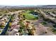 Aerial view of a home with a pool, backing onto a lush golf course at 129 Chateau Whistler Ct, Las Vegas, NV 89148