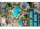 Aerial shot showcasing the resort-style pool, tennis courts, playground, and lush landscaping within the community at 129 Chateau Whistler Ct, Las Vegas, NV 89148