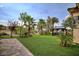 Expansive backyard with manicured lawn, mature trees, and a comfortable hammock at 129 Chateau Whistler Ct, Las Vegas, NV 89148