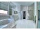 Elegant bathroom with soaking tub, double vanities, and bright natural light at 129 Chateau Whistler Ct, Las Vegas, NV 89148