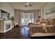 Inviting bedroom with dark wood floors, a cozy bed, and bright windows at 129 Chateau Whistler Ct, Las Vegas, NV 89148