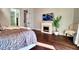 Comfortable bedroom featuring fireplace, tv, and a large cozy bed at 129 Chateau Whistler Ct, Las Vegas, NV 89148
