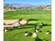 Picturesque view of geese resting on a golf course, with a lake and mountains in the distance at 129 Chateau Whistler Ct, Las Vegas, NV 89148