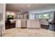 Open kitchen area with a large island and elegant tile flooring at 129 Chateau Whistler Ct, Las Vegas, NV 89148