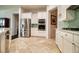 Modern kitchen with stainless steel appliances, white cabinetry, and tile backsplash at 129 Chateau Whistler Ct, Las Vegas, NV 89148