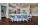 Bright kitchen boasts a large island with bar seating, stainless steel appliances and white cabinets for a modern feel at 129 Chateau Whistler Ct, Las Vegas, NV 89148