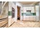 Well-equipped kitchen featuring stainless steel appliances and an oven, complemented by white cabinetry and tile flooring at 129 Chateau Whistler Ct, Las Vegas, NV 89148